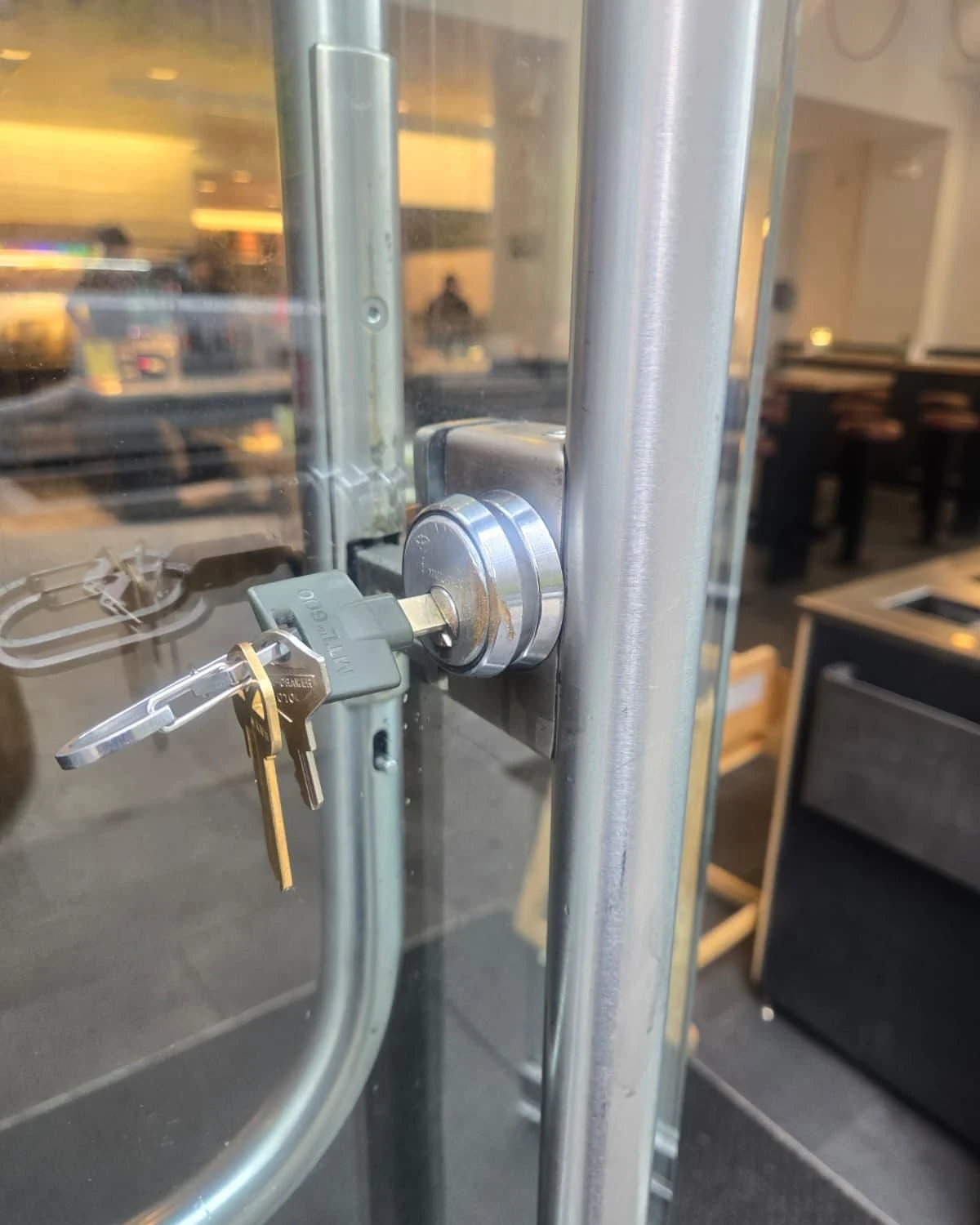 Mobile locksmith at a commercial storefront in Vaughan, Ontario, with high-security cylinder service